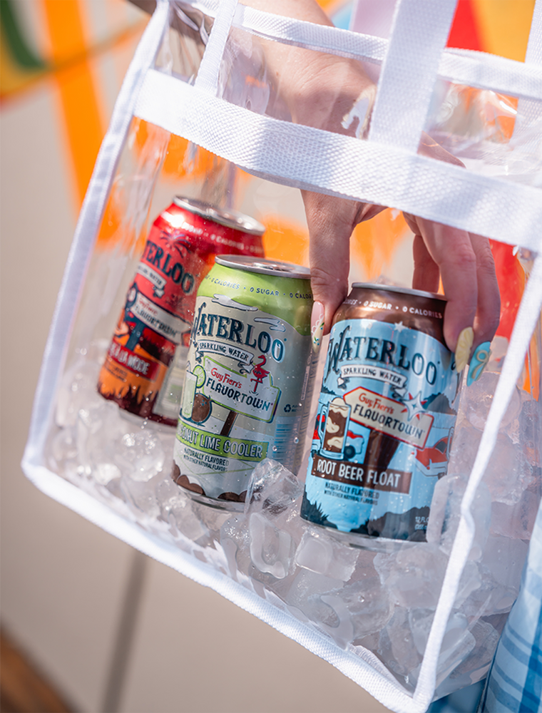 Hand holding a clear bag of Waterloo sparkling water cans on ice, showcasing flavors like Root Beer Float and Lime Cooler.