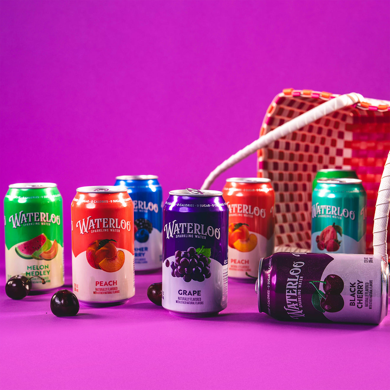 Various Waterloo sparkling water cans displayed with a colorful basket against a vibrant purple background.