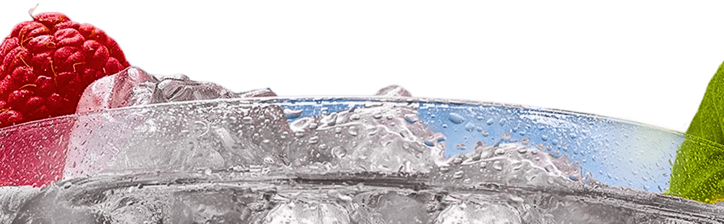 Close-up of a refreshing drink with raspberries and a lime slice, surrounded by ice and condensation.