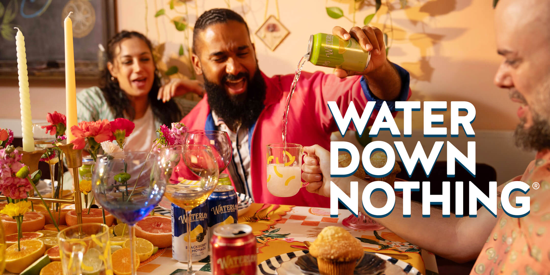 Friends enjoying a vibrant gathering with fruit, drinks, and laughter, promoting a lively celebration of enjoyment.