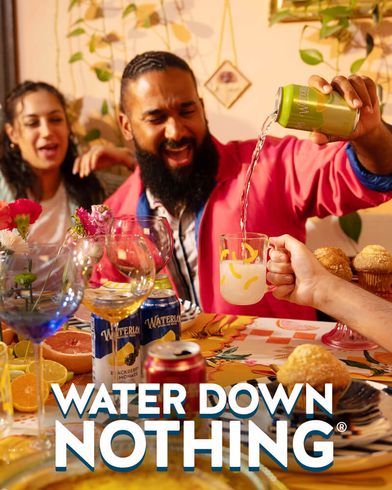 Friends enjoying a vibrant gathering, pouring refreshing Waterlooo drinks and celebrating with food and laughter.