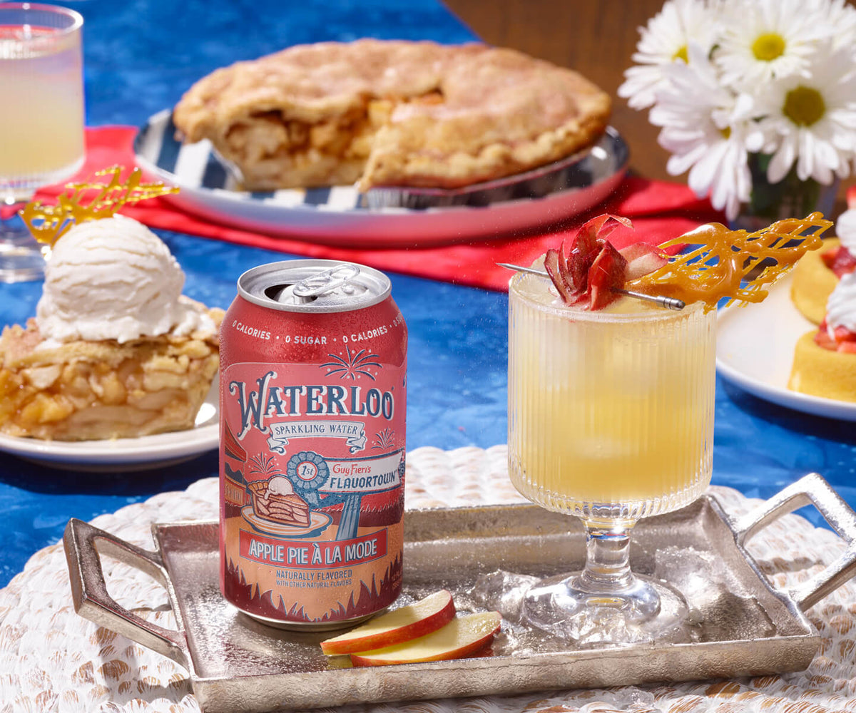 Can of Waterloo Apple Pie sparkling water with a cocktail and apple pie dessert on a festive table.