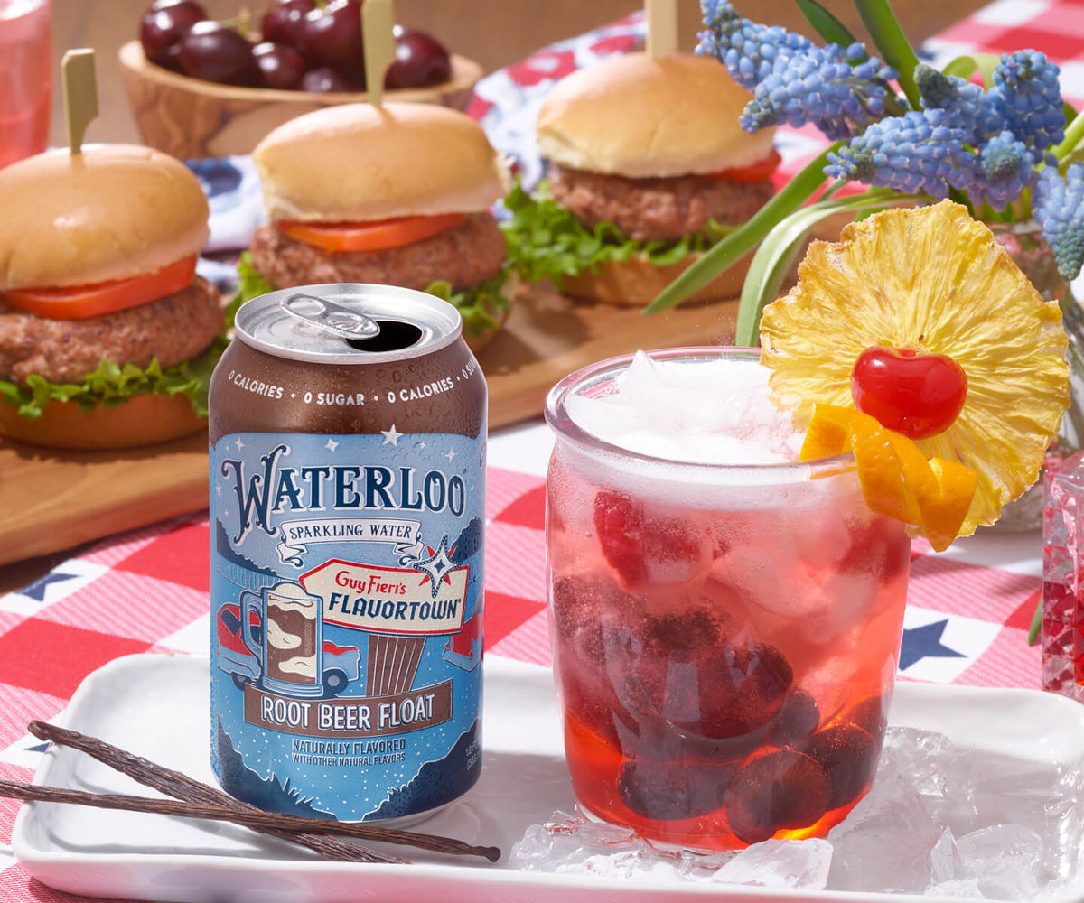 A refreshing glass of sparkling root beer float next to sliders with lettuce and tomato, perfect for summer picnics.