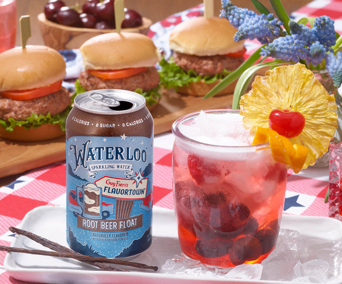 A refreshing glass of sparkling root beer float next to sliders with lettuce and tomato, perfect for summer picnics.
