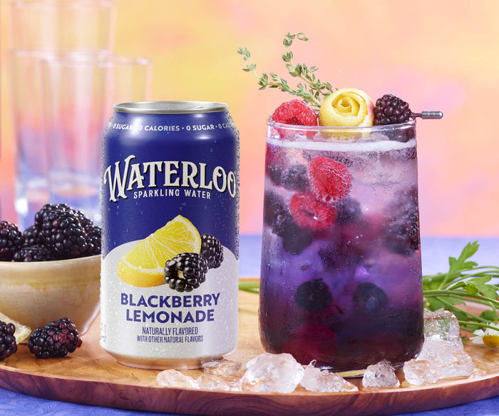 Can of Waterloo Blackberry Lemonade next to a glass of sparkling water filled with berries and ice.